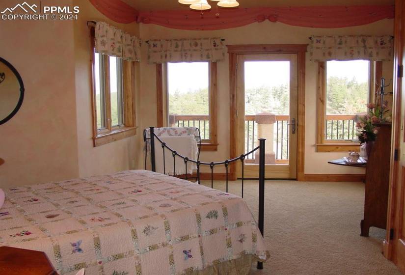 Bedroom featuring light colored carpet and access to exterior
