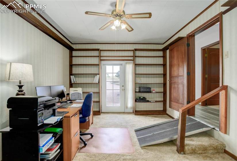 Office space featuring ceiling fan, light carpet, and ornamental molding
