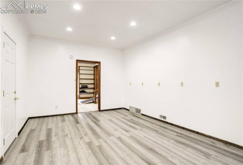 Unfurnished room with ornamental molding and light hardwood / wood-style floors