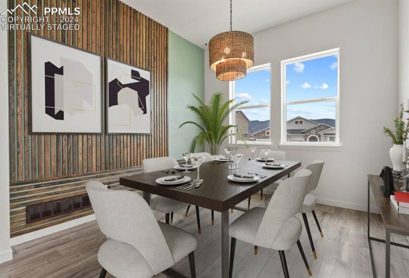 *Virtually Staged* Dining room featuring hardwood / wood-style floors and an inviting chandelier