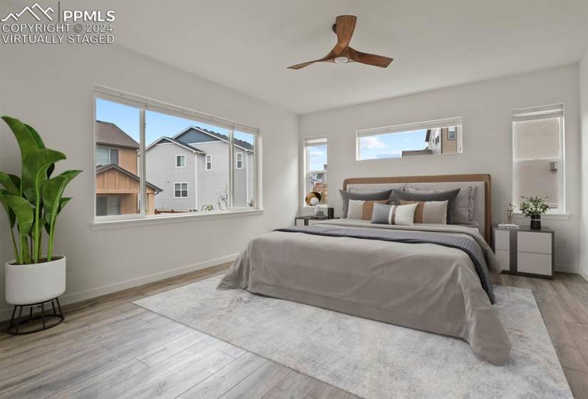 *Virtually Staged* Master bedroom featuring light hardwood / wood-style flooring and ceiling fan