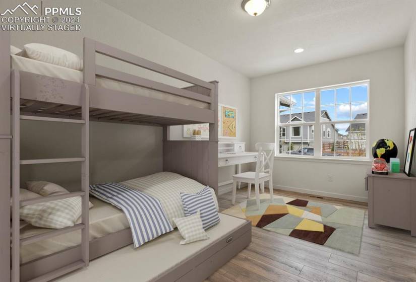 *Virtually Staged* Main level bedroom with light hardwood / wood-style floors