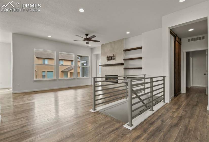 Great room with cosmo fireplace, stairs leading to basement