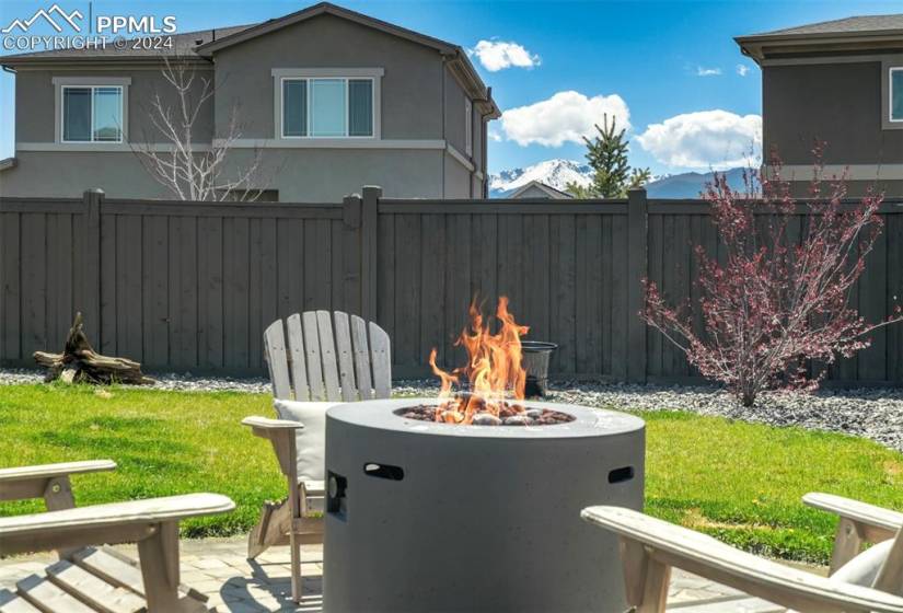 View of yard with a patio and an outdoor fire pit