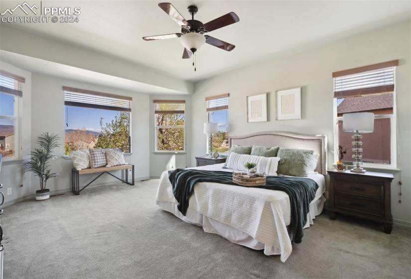 Carpeted primary bedroom featuring ceiling fan
