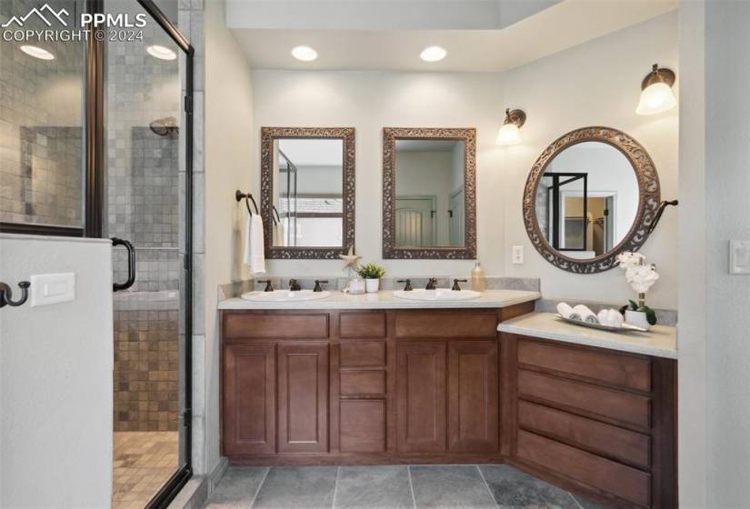Bathroom featuring a standing shower, and double sink vanity