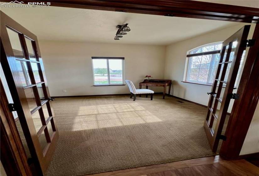 Bedroom/office, carpet with french doors & two closets