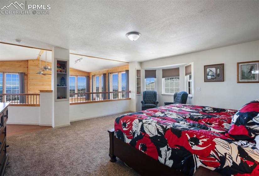 Primary suite on the upper level overlooking the living room and beautiful mountain views