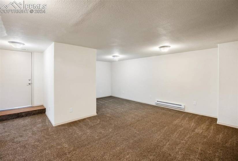 Basement carpeted with lots of storag and walkout