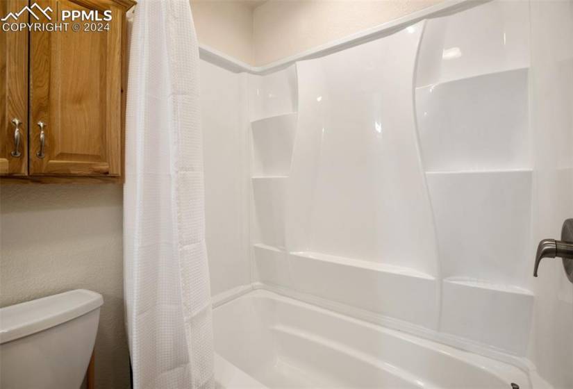 Basement bathroom with tub/shower surround, heated floor