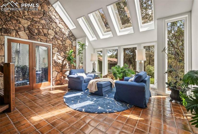 Sunroom with a skylight and french doors