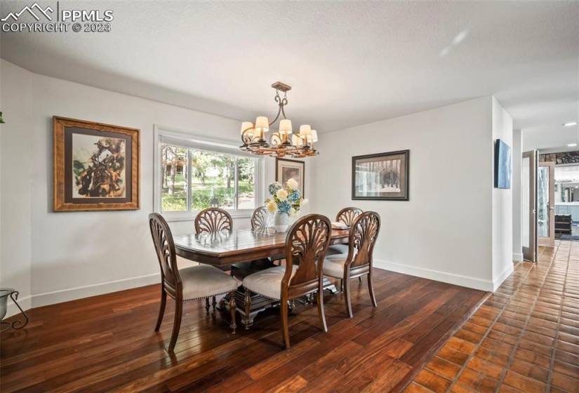 Dining room with an inviting chandelier and dark hardwood / wood-style flooring
