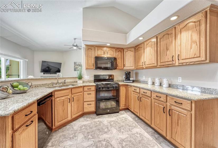 Appliances include a dishwasher, gas range double oven, and built-in microwave oven.