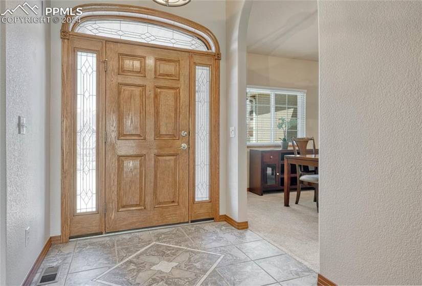 Beautiful front tiled Entry with lead glass door frame.