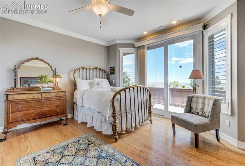 Bedroom featuring ornamental molding, light hardwood / wood-style flooring, ceiling fan, and access to outside