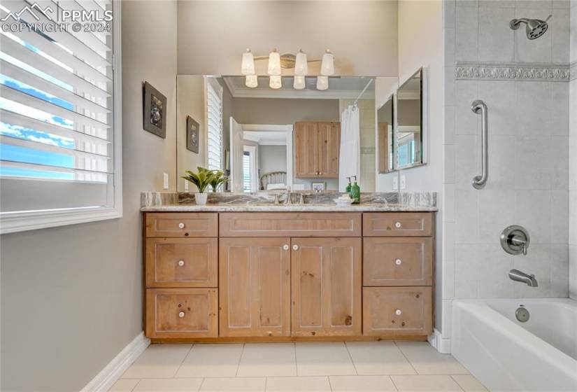 Bathroom with a healthy amount of sunlight, vanity, and tile floors