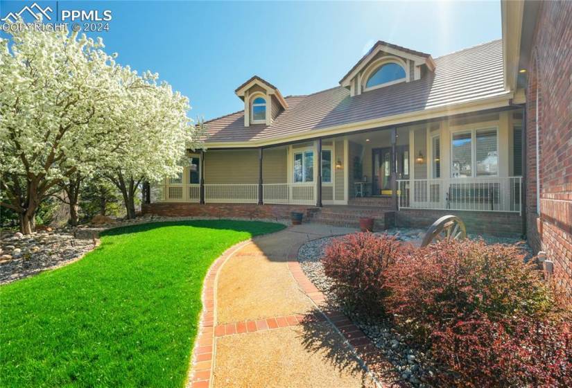 View of front of property with a porch and a front yard