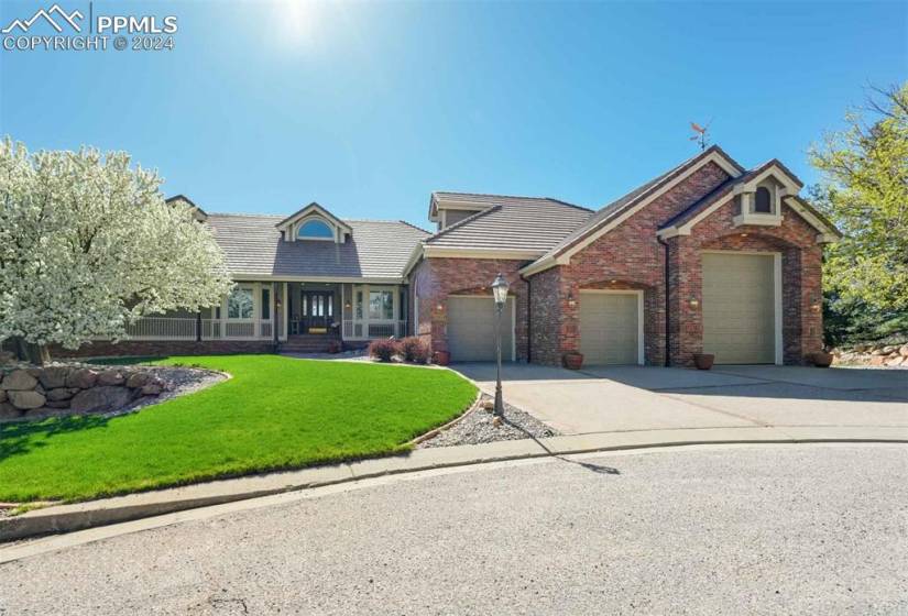 View of front of house with a garage and a front yard