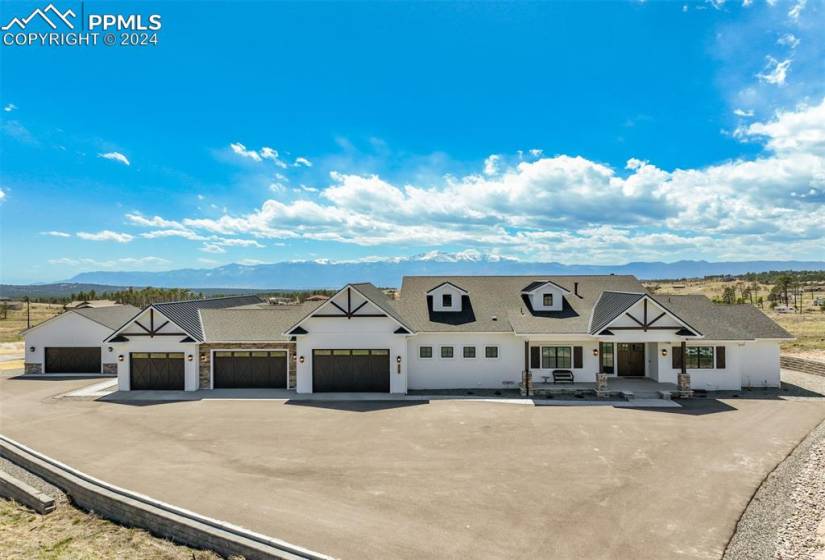 Custom home on 2.67 acres with attached 4 car garage, attached guest apartment with a one car garage, detached garage/shop, RV parking with hookups, and sweeping Mountain Views.