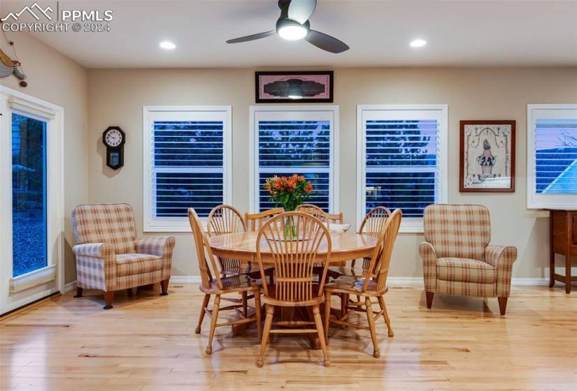 Dining space with light hardwood / wood-style floors, plenty of natural light, and ceiling fan