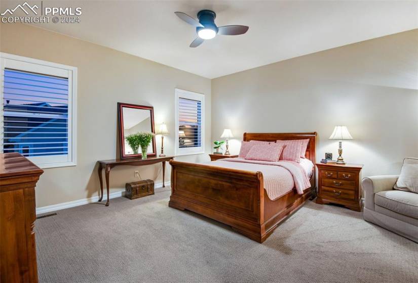 Bedroom with ceiling fan and carpet floors