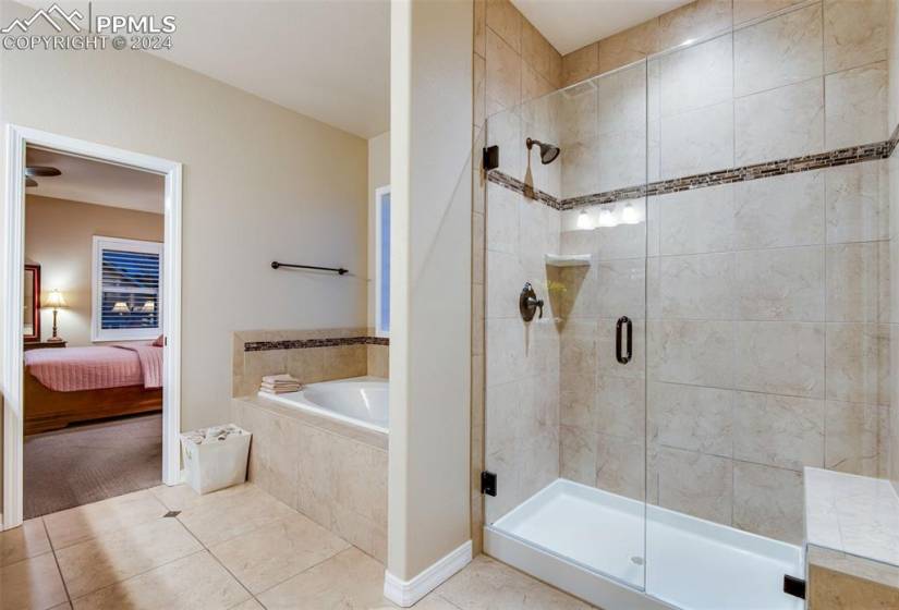 Bathroom with tile flooring and plus walk in shower