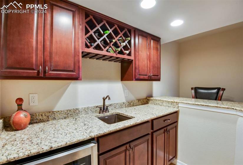 Kitchen featuring sink and light stone counters