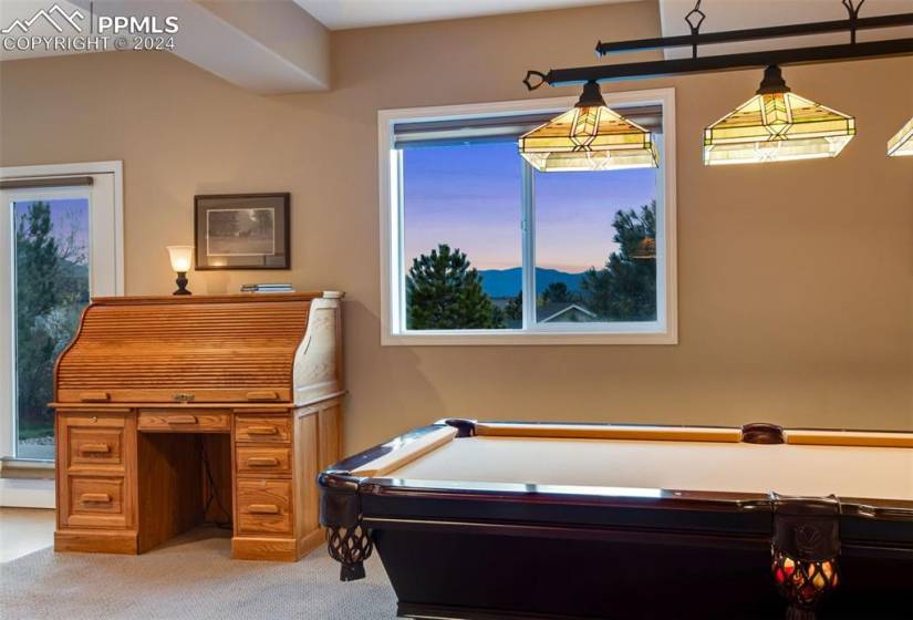 Recreation room with carpet floors and pool table