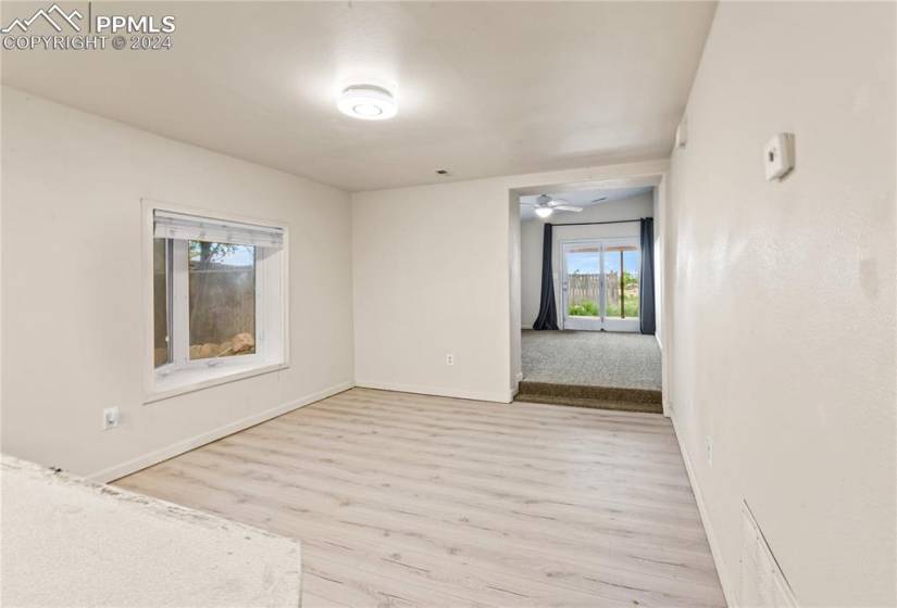 Carpeted empty room featuring ceiling fan