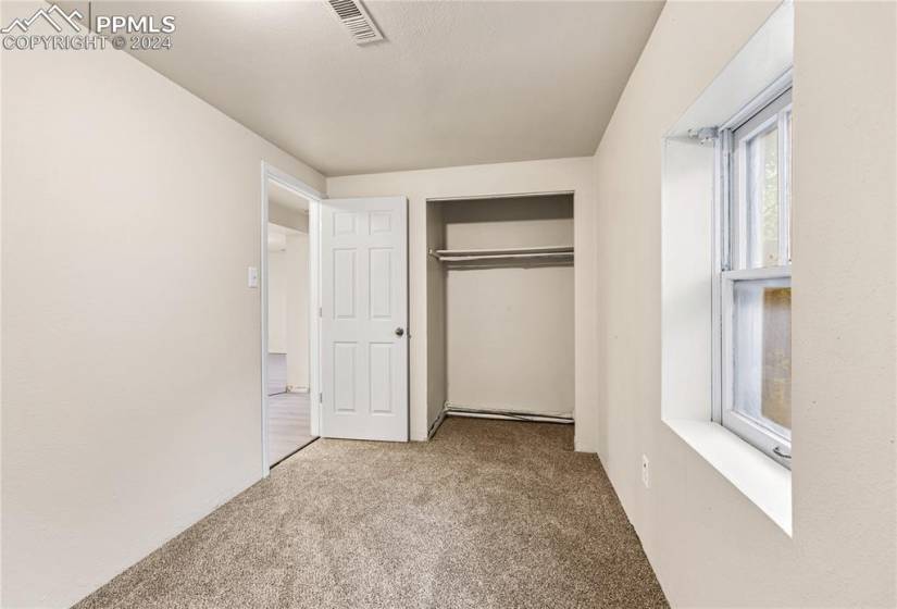 Unfurnished bedroom featuring a closet and carpet floors