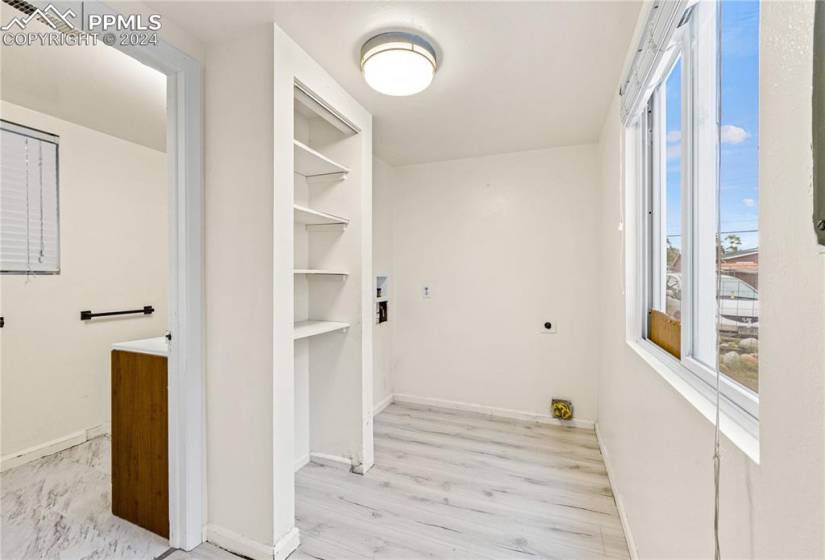 Laundry room featuring light hardwood / wood-style floors, washer hookup, and hookup for an electric dryer