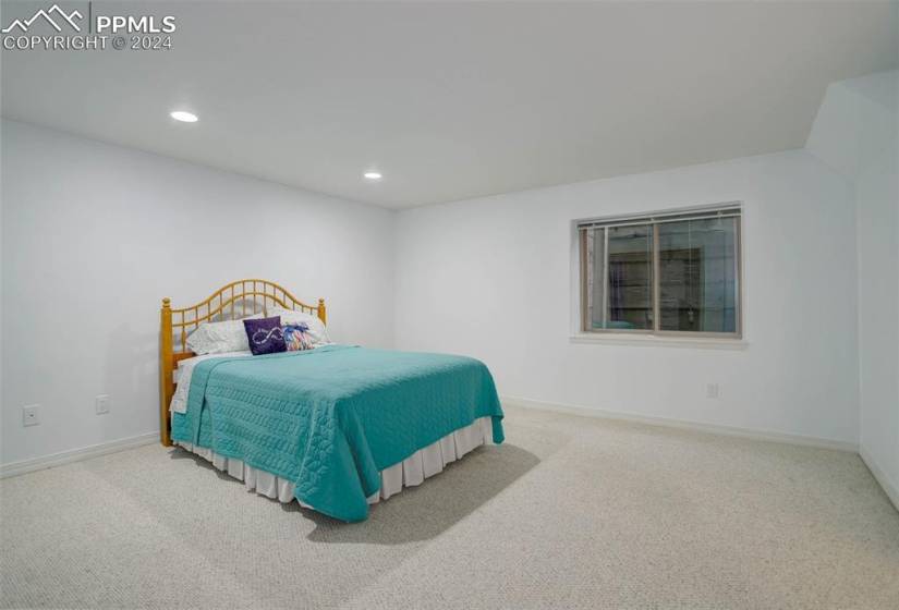 Second basement bedroom with carpeted flooring