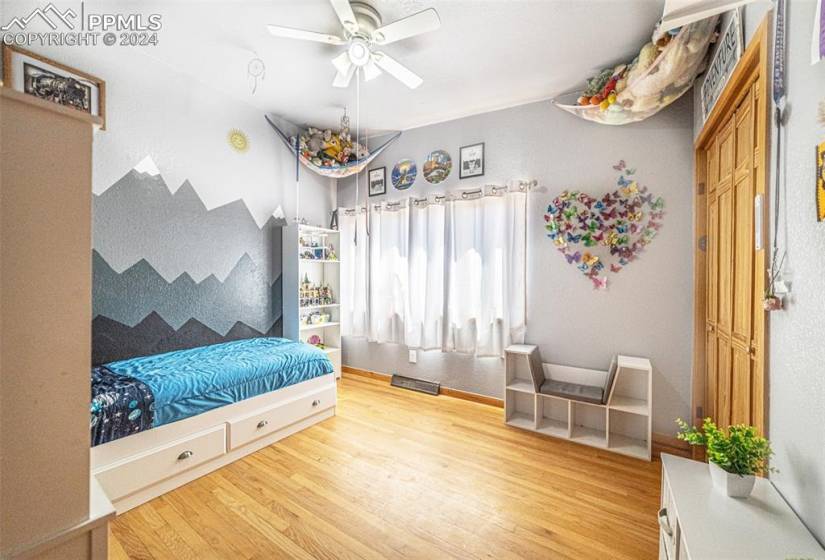 Bedroom featuring light wood-type flooring and ceiling fan