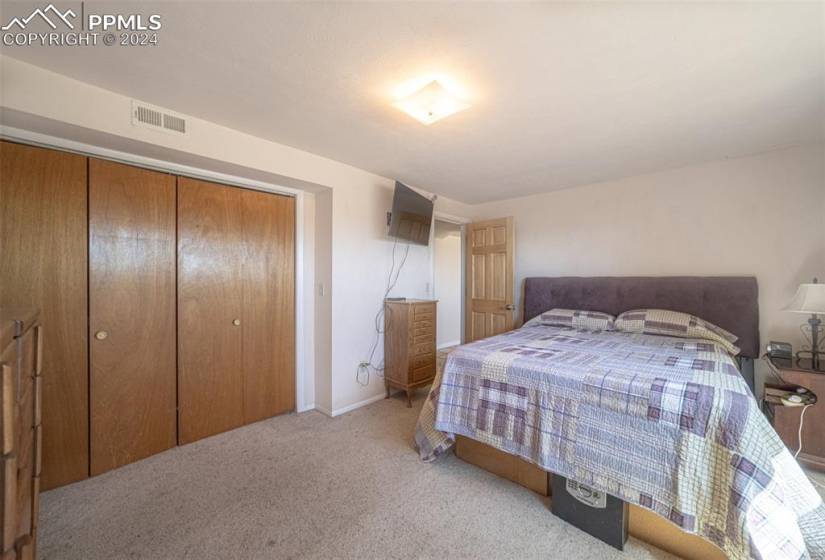 Bedroom featuring a closet and light carpet