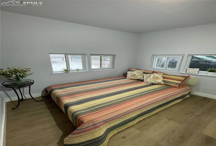 Bedroom with wood-type flooring