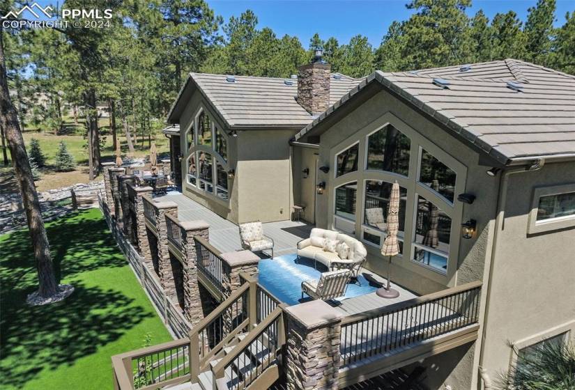 Rear of home with artificial turf, new deck, 2024 and beautiful landscaping.