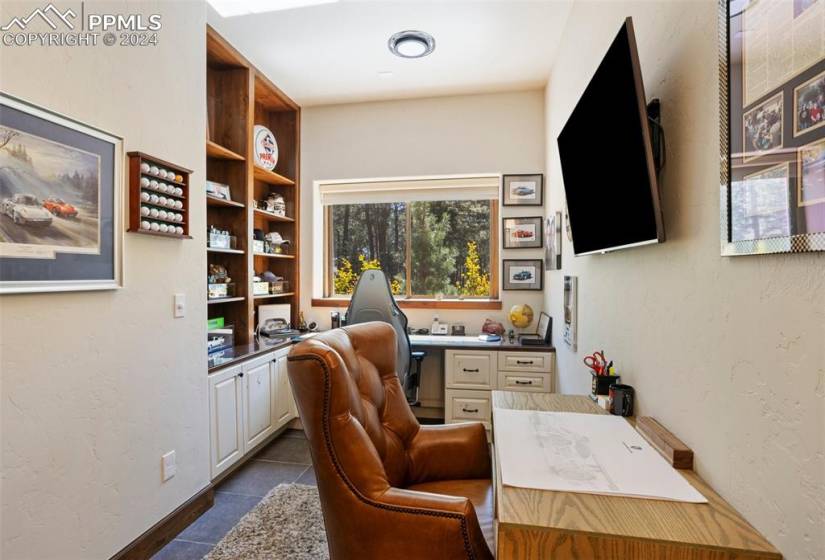 Basement formal office room with BI desk and glass door!