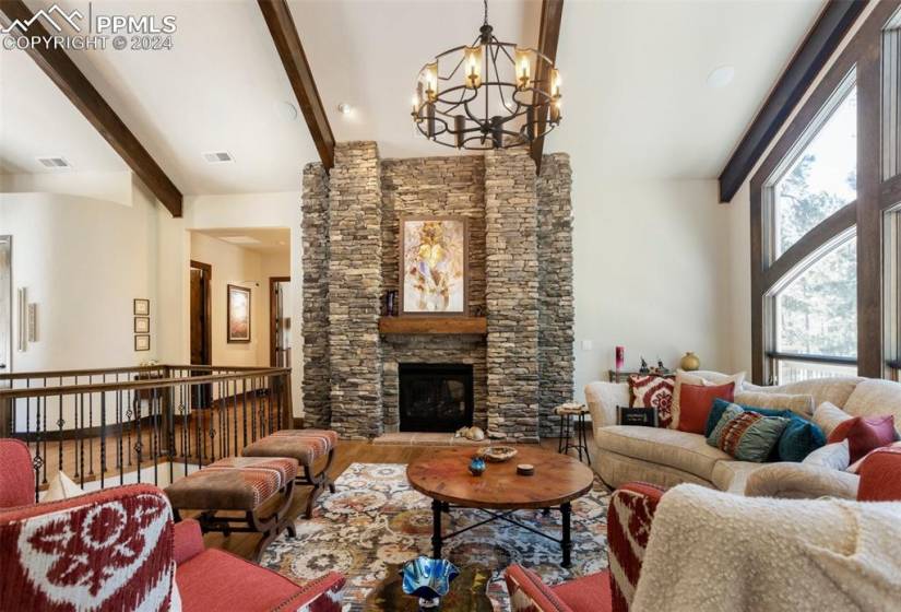 Living room with gas fireplace and beamed ceilings