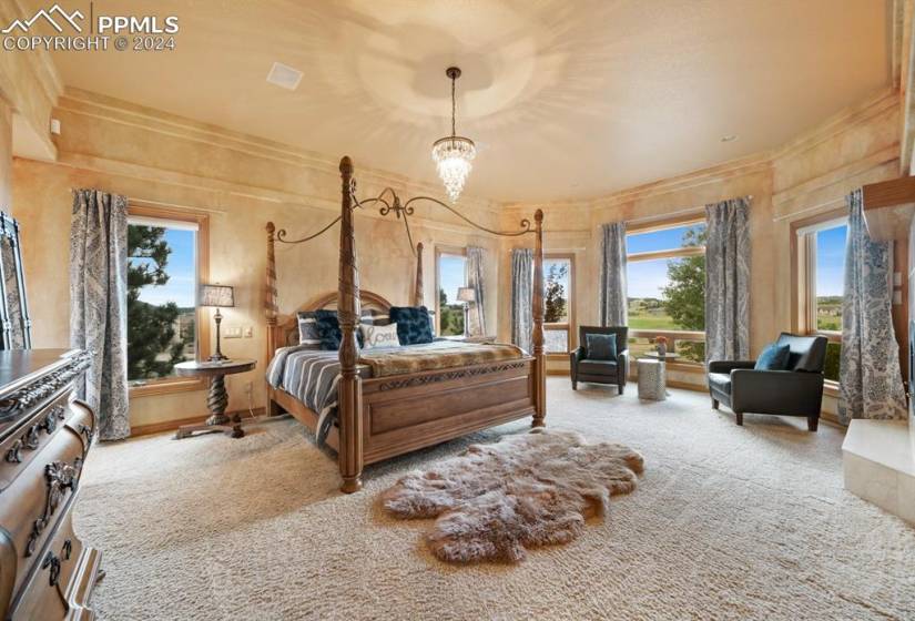 Carpeted bedroom featuring a chandelier and crown molding