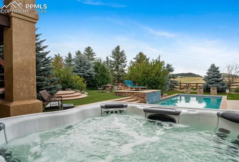 View of pool with a fire pit