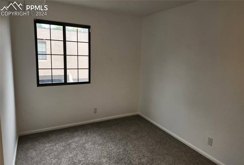 Carpeted spare room featuring plenty of natural light