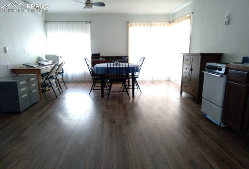 Dining space with ceiling fan and dark hardwood / wood-style floors