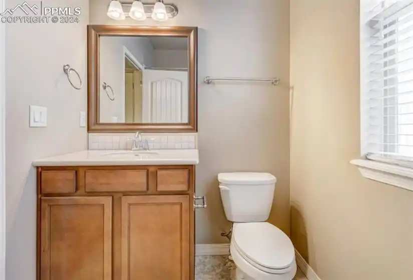 Bathroom featuring vanity, toilet, and tile patterned floors