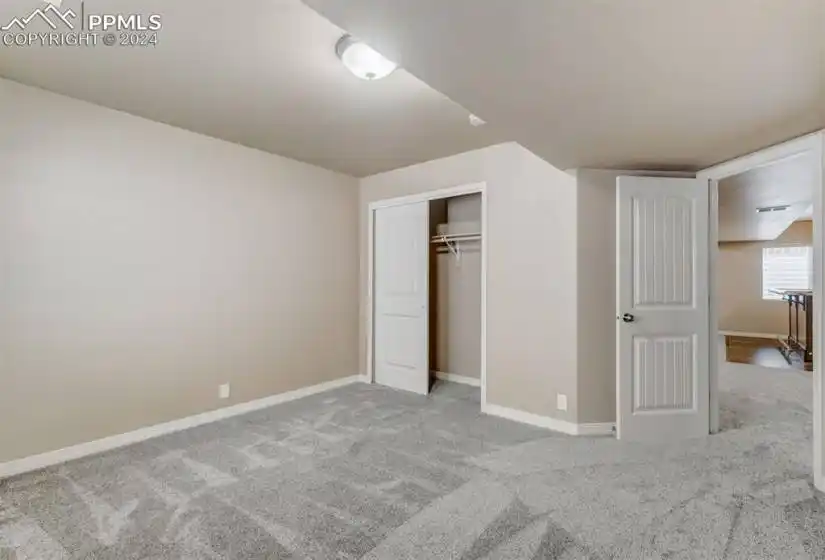 Unfurnished bedroom featuring carpet and a closet