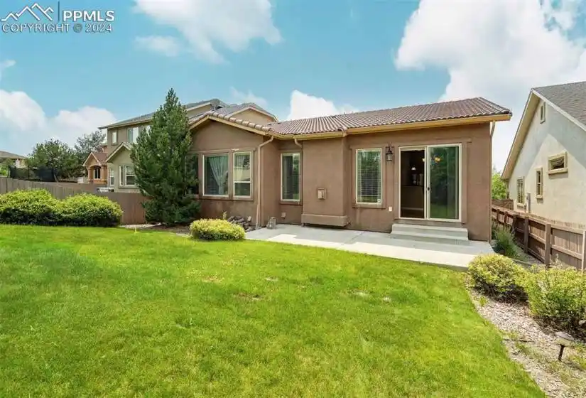Rear view of property featuring a lawn