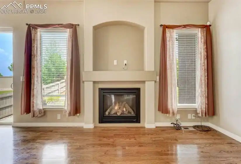 Unfurnished living room featuring hardwood / wood-style flooring