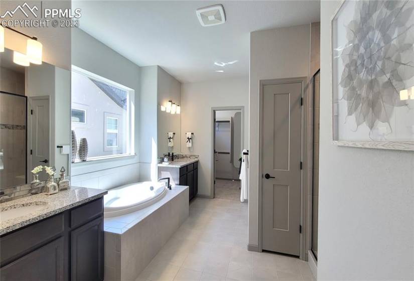 Spa-like, 5-piece Bathroom with soaking tub, separate vanities, shower, linen closet, and water closet!