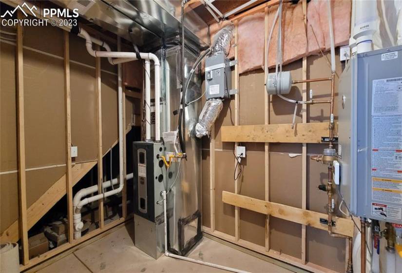 Utility room with tankless water heater, 96% energy efficient furnace with a variable speed motor, pex water piping, and sealed ducts in this energy rated home!