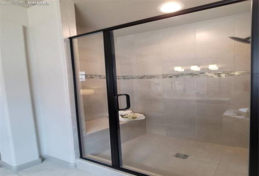 Primary Shower with bench and tile surrounds!