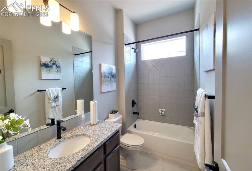 Full Bathroom with granite slab countertop and tile surrounds!